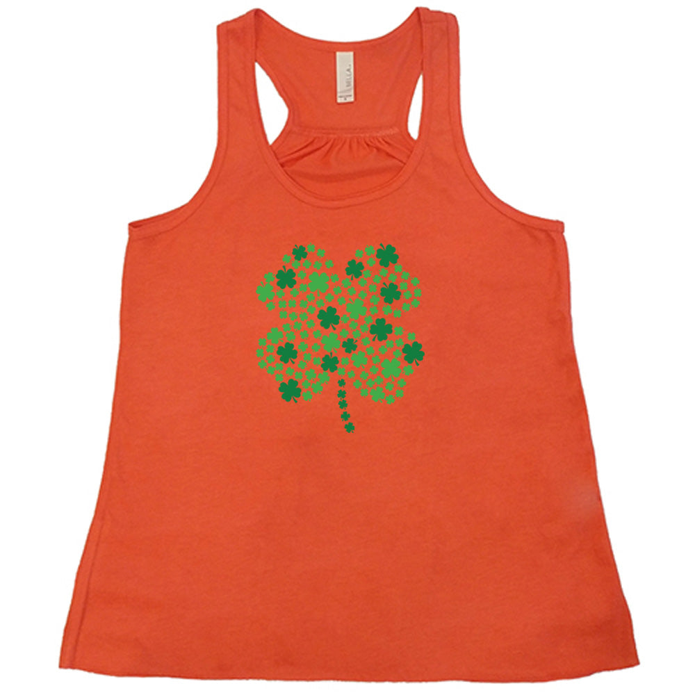 coral shirt with a shamrock graphic on it