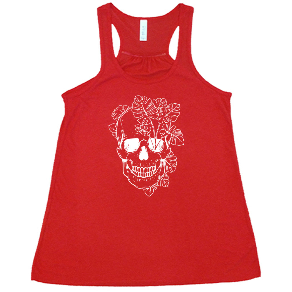 Red colored flowy tank with a monstera plant and skull graphic on it