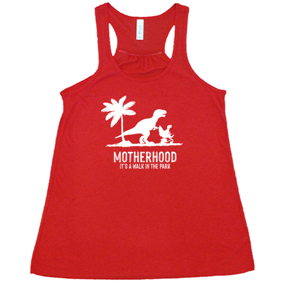 Red colored flowy tank with a mother and child dinosaur graphic on it that says "Motherhood, Its a Walk in the Park" 