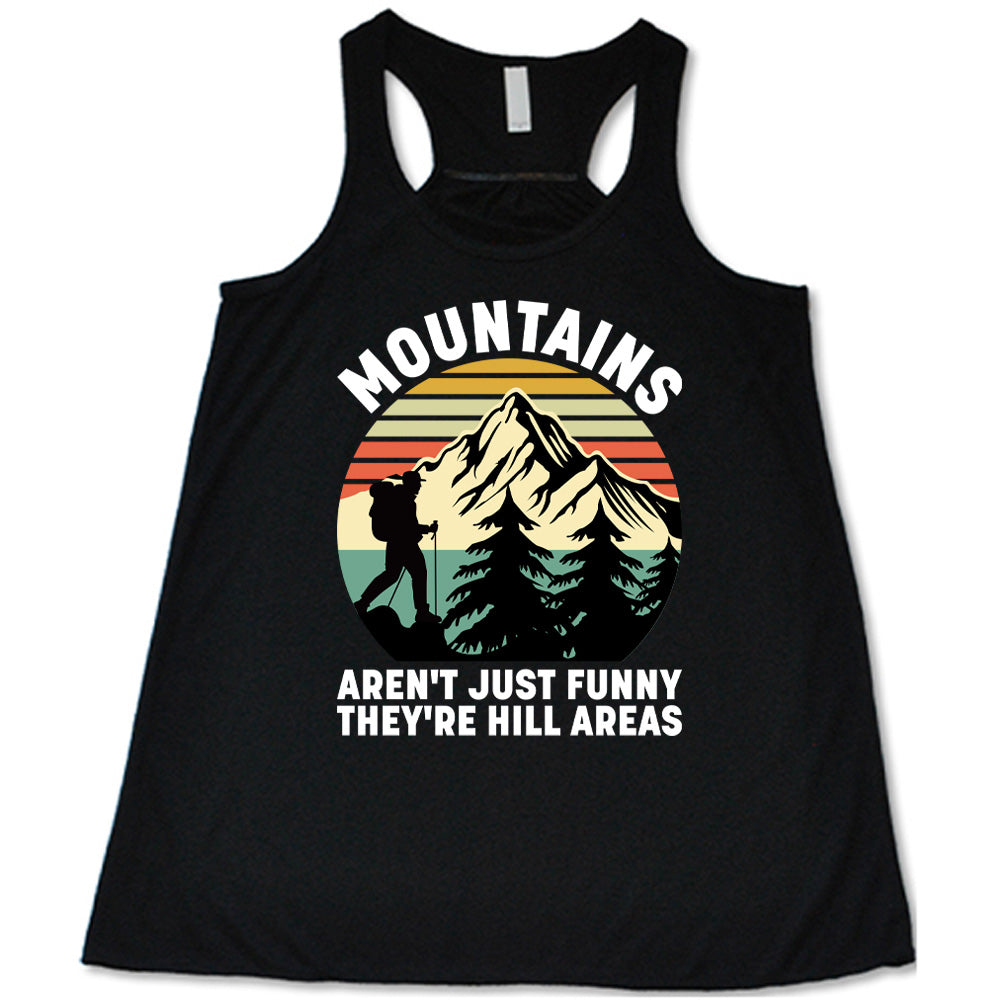 black flowy tank with the words "mountains aren't just funny they're hill areas" on it, with the graphic of a mountain, trees, a colorful sky, and the silhouette of a hiker