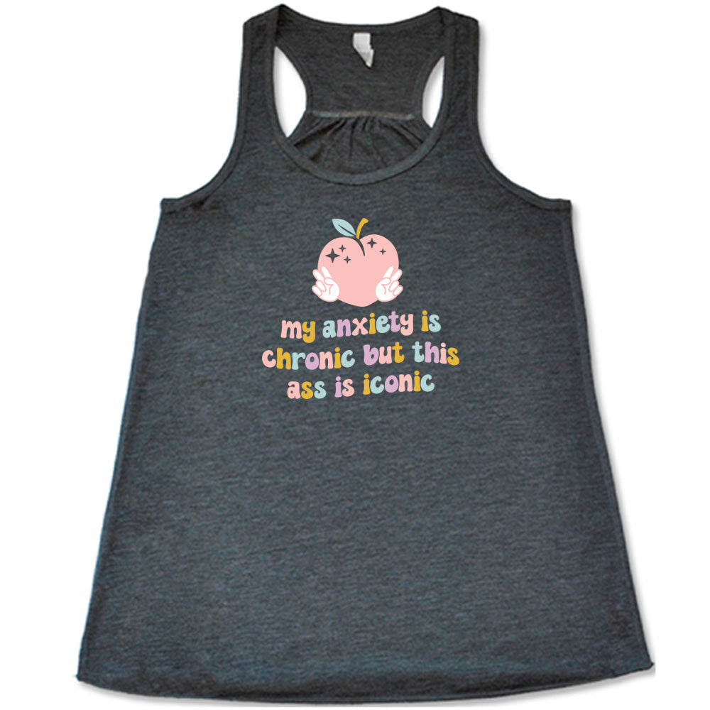 Grey colored flowy tank with a peach and peace signs graphic on it that says "My Anxiety Is Chronic But This Ass Is Iconic"