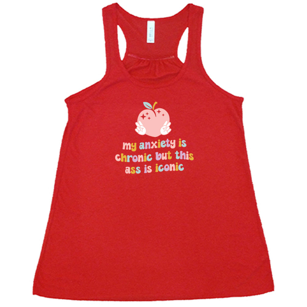 Red colored flowy tank with a peach and peace signs graphic on it that says "My Anxiety Is Chronic But This Ass Is Iconic" 