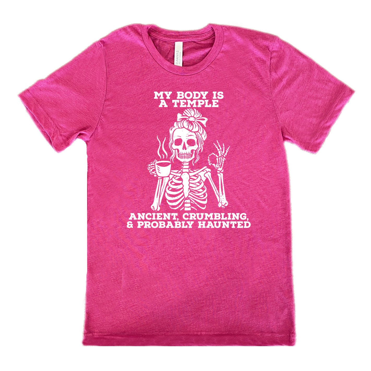 berry unisex tee with the words "My Body Is a Temple Ancient, Crumbling, & Probably Haunted" on it, with the graphic of a skeleton with its hair in a bow, with one hand holding steaming coffee, and the other giving the OK symbol