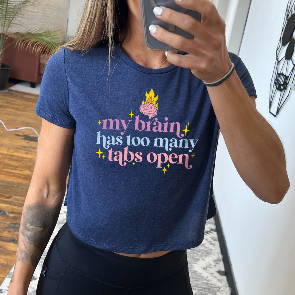 heather navy cropped tee with a flaming brain graphic on it that says "My Brain Has Too Many Tabs Open" 