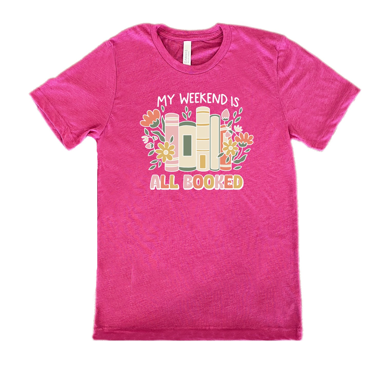 Berry colored shirt with books and flowers graphic on it that says "My Weekend Is All Booked" 