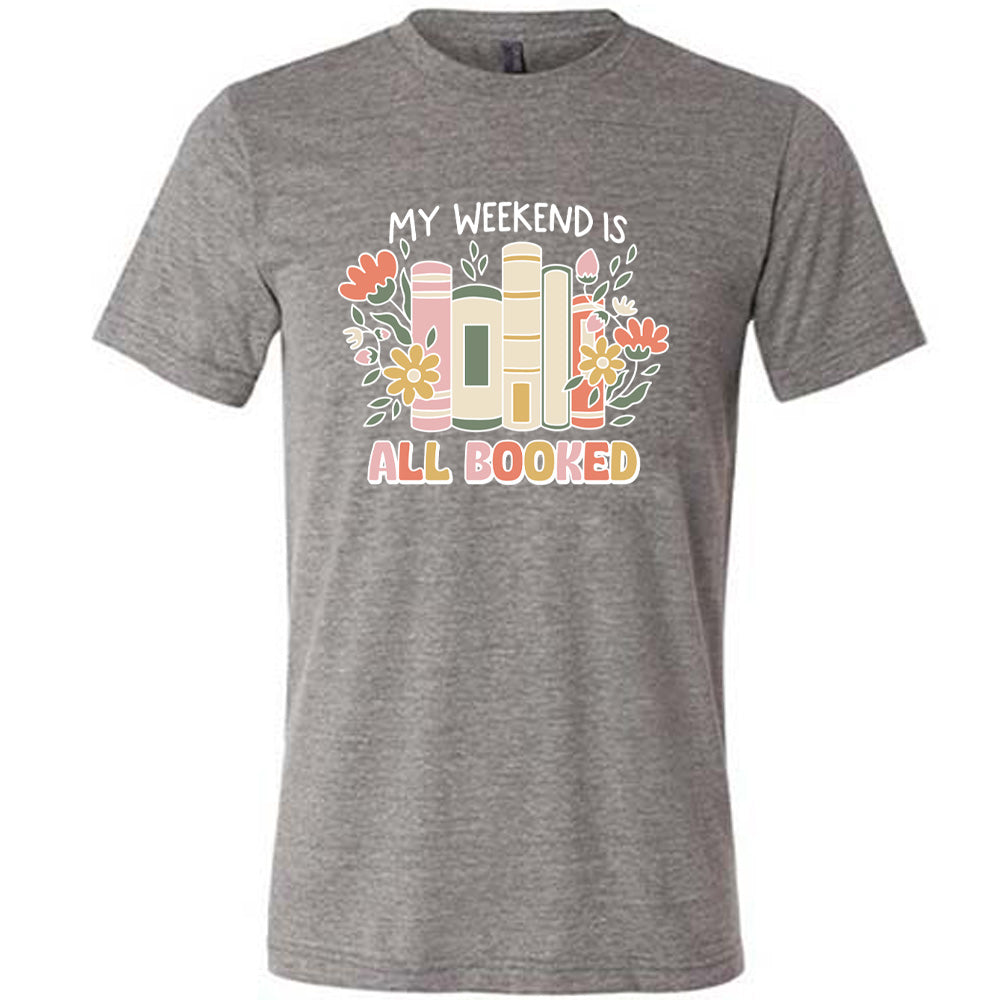 Grey colored shirt with books and flowers graphic on it that says "My Weekend Is All Booked" 