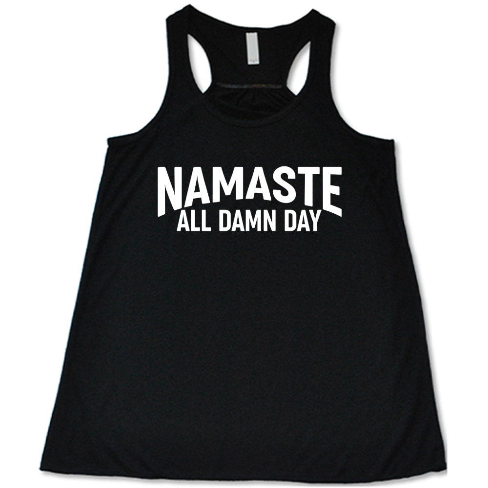 black flowy tank with the words "Namaste all damn day" on it