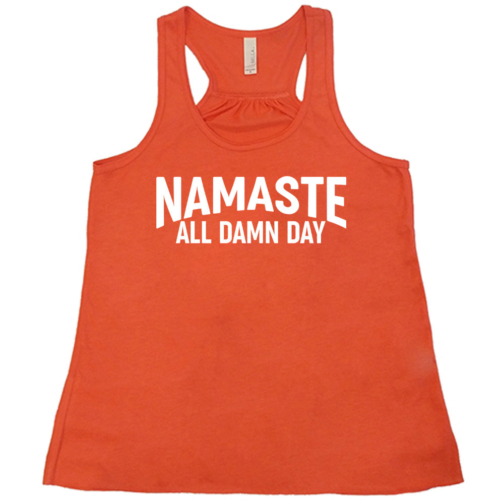 coral flowy tank with the words "Namaste all damn day" on it