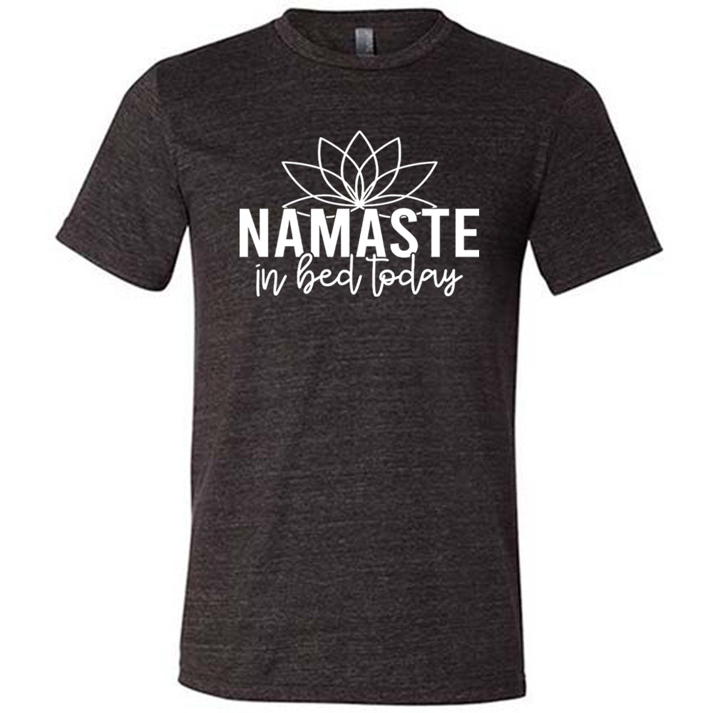 Black unisex tee with the words "Namaste in bed today" with a line art of a lotus flower above it