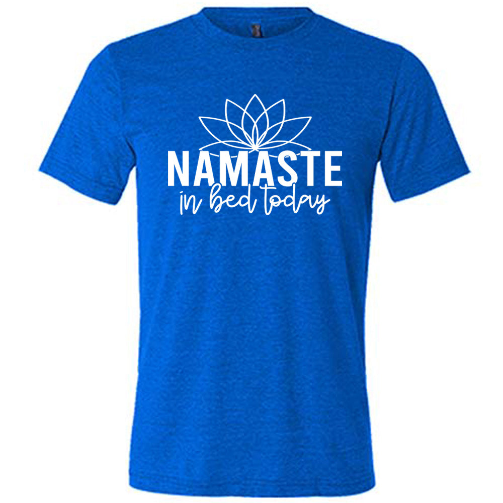Blue unisex tee with the words "Namaste in bed today" with a line art of a lotus flower above it