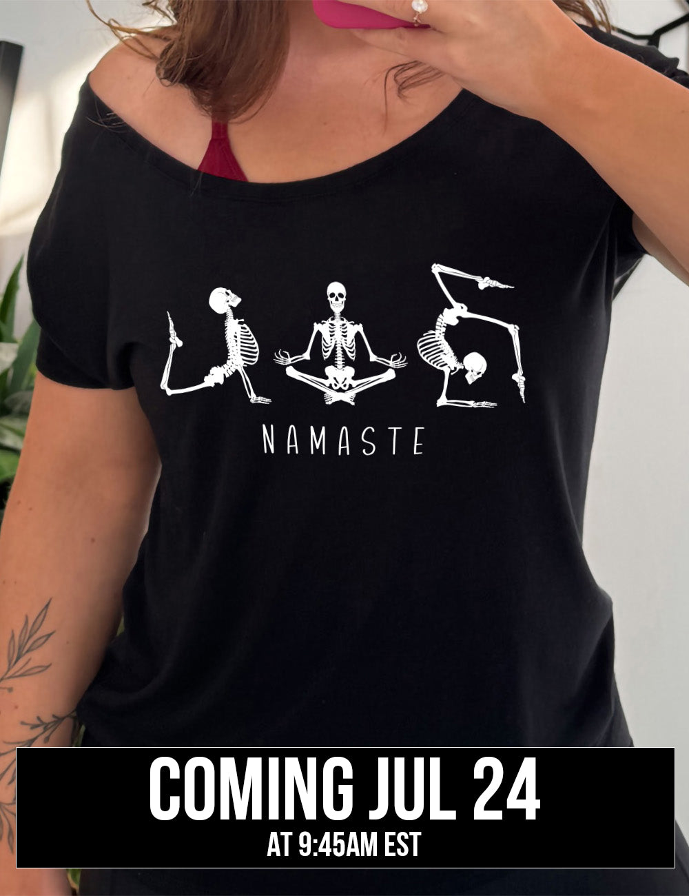 black slouchy tee with the graphic of three skeletons, all doing yoga poses, and the word underneath saying "namaste" coming july 24th