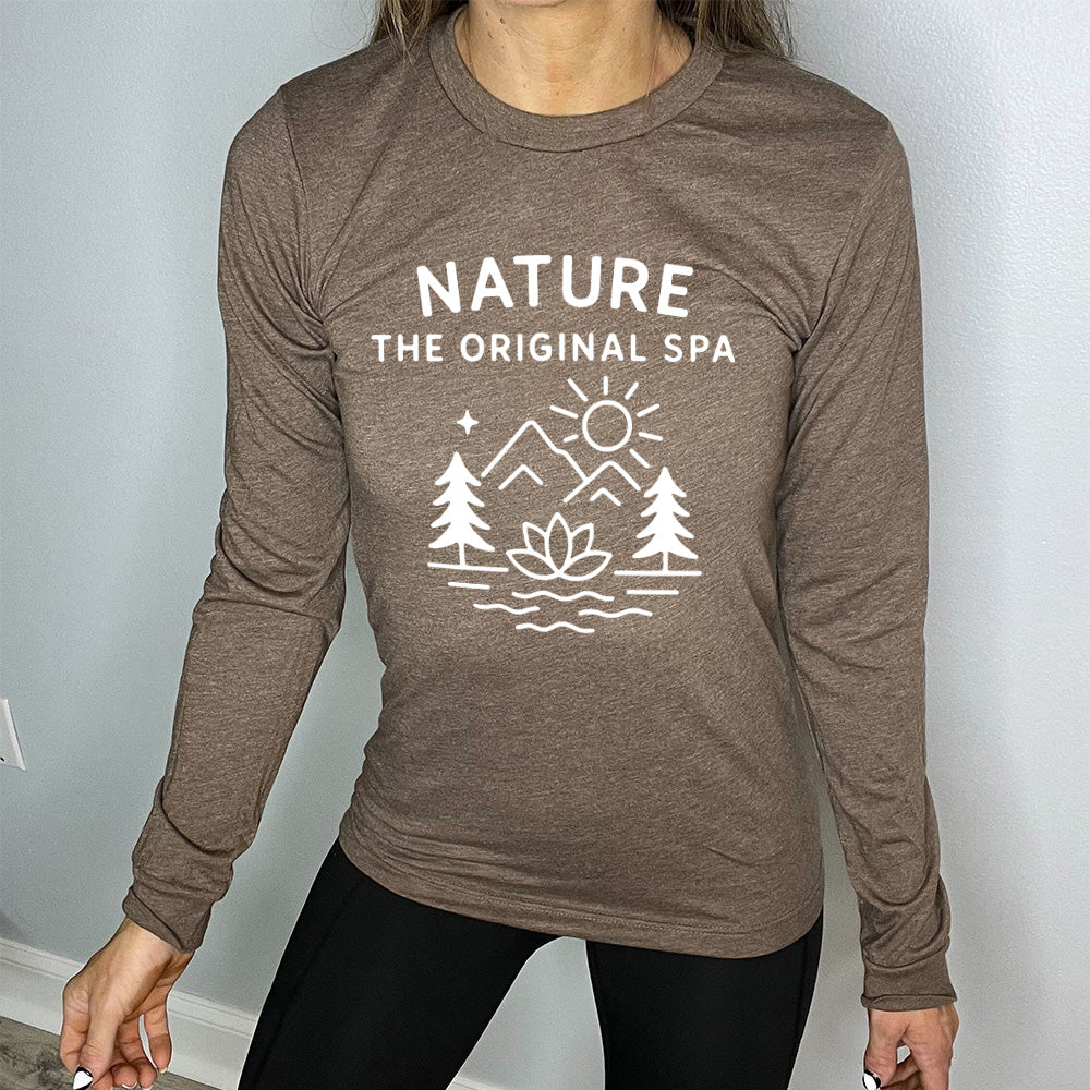 heather brown long sleeve with the words "nature the original spa" on it, with the mostly line-art graphic of the sun, mountains, trees, a single star, water, and a lotus flower