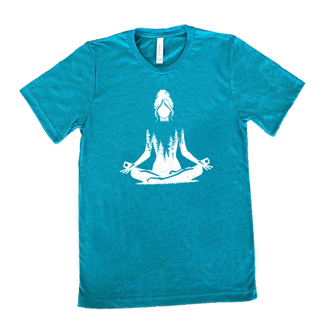 Teal unisex tee with the graphic of a woman doing a yoga pose, with her shoulders to waist being the silhouette of a forest  