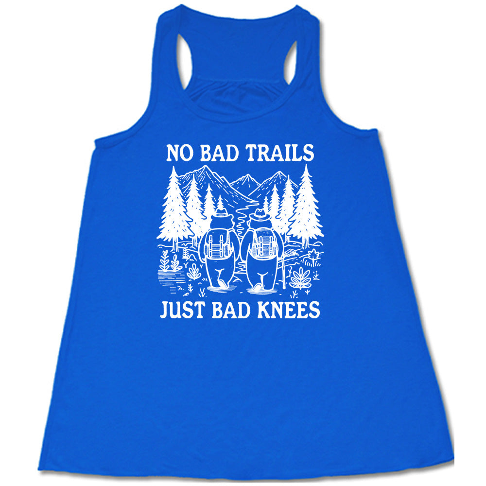 Blue colored flowy tank with two bears hiking graphic on it that says "No Bad Trails Just Bad Knees" 