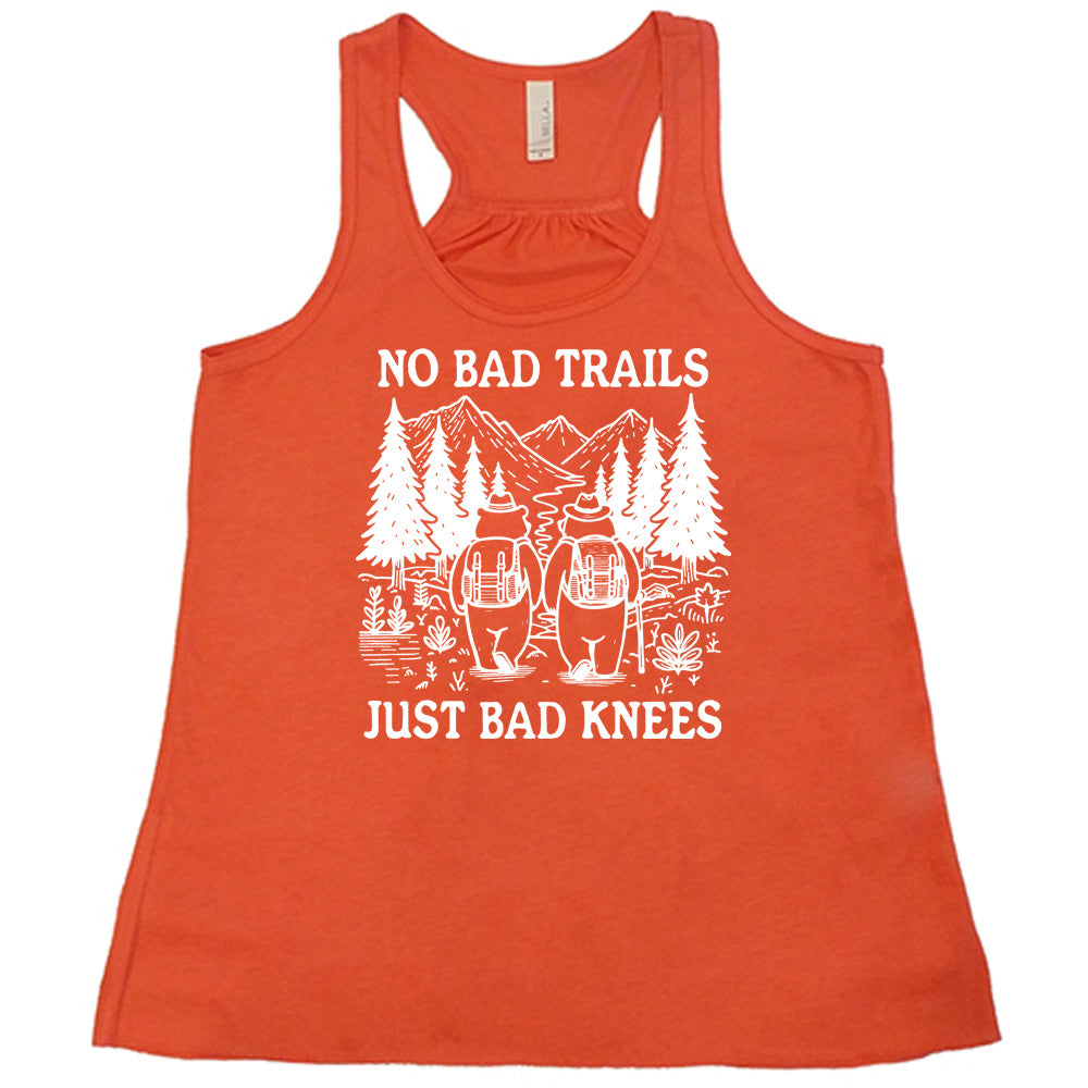 Coral colored flowy tank with two bears hiking graphic on it that says "No Bad Trails Just Bad Knees" 