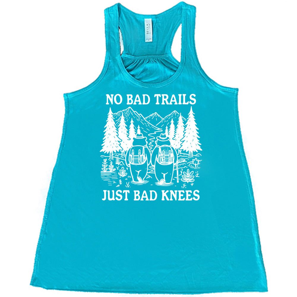 Teal colored flowy tank with two bears hiking graphic on it that says "No Bad Trails Just Bad Knees" 