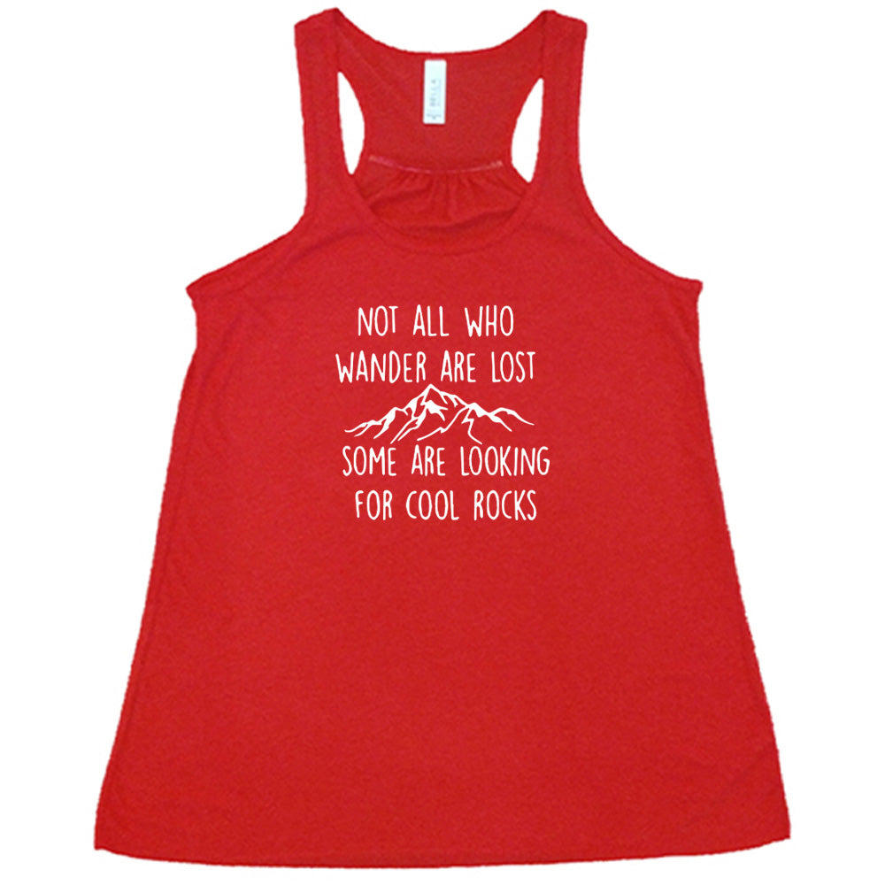 Red colored flowy tank with a mountain graphic on it that says "Not All Who Wander Are Lost Some Are Looking For Cool Rocks" 
