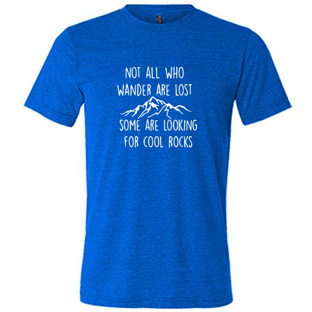 Blue colored shirt with a mountain graphic on it that says "Not All Who Wander Are Lost Some Are Looking For Cool Rocks" 