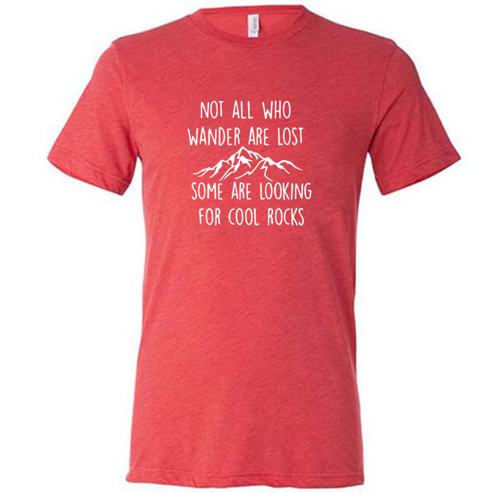 Red colored shirt with a mountain graphic on it that says "Not All Who Wander Are Lost Some Are Looking For Cool Rocks" 