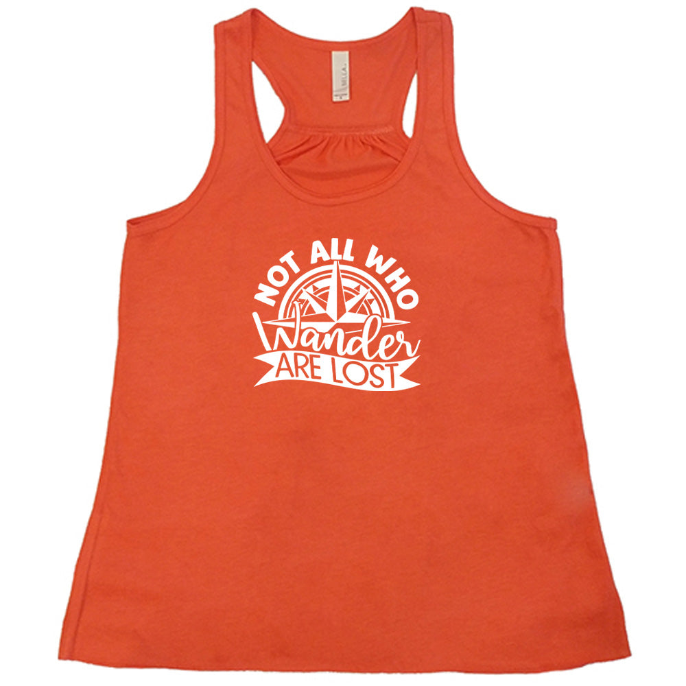 Coral colored flowy tank with a compass graphic on it that says "Not All Who Wander Are Lost" 