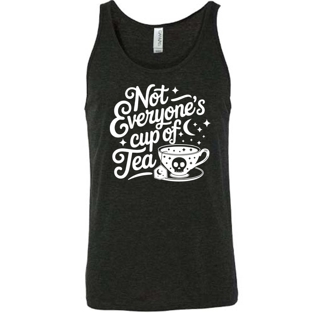 black unisex tank with the words "not everyone's cup of a tea" in a cursive font, with the graphics of a moon and little stars, and a tea cup with a skull on it with stars and the tea bag has a moon on it