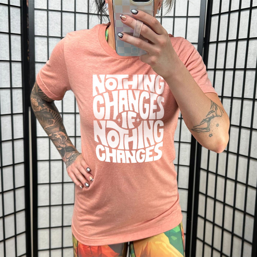 sunset unisex tee with the words "nothing changes if nothing changes" on it, with two tiny stars on either side of the word "if"