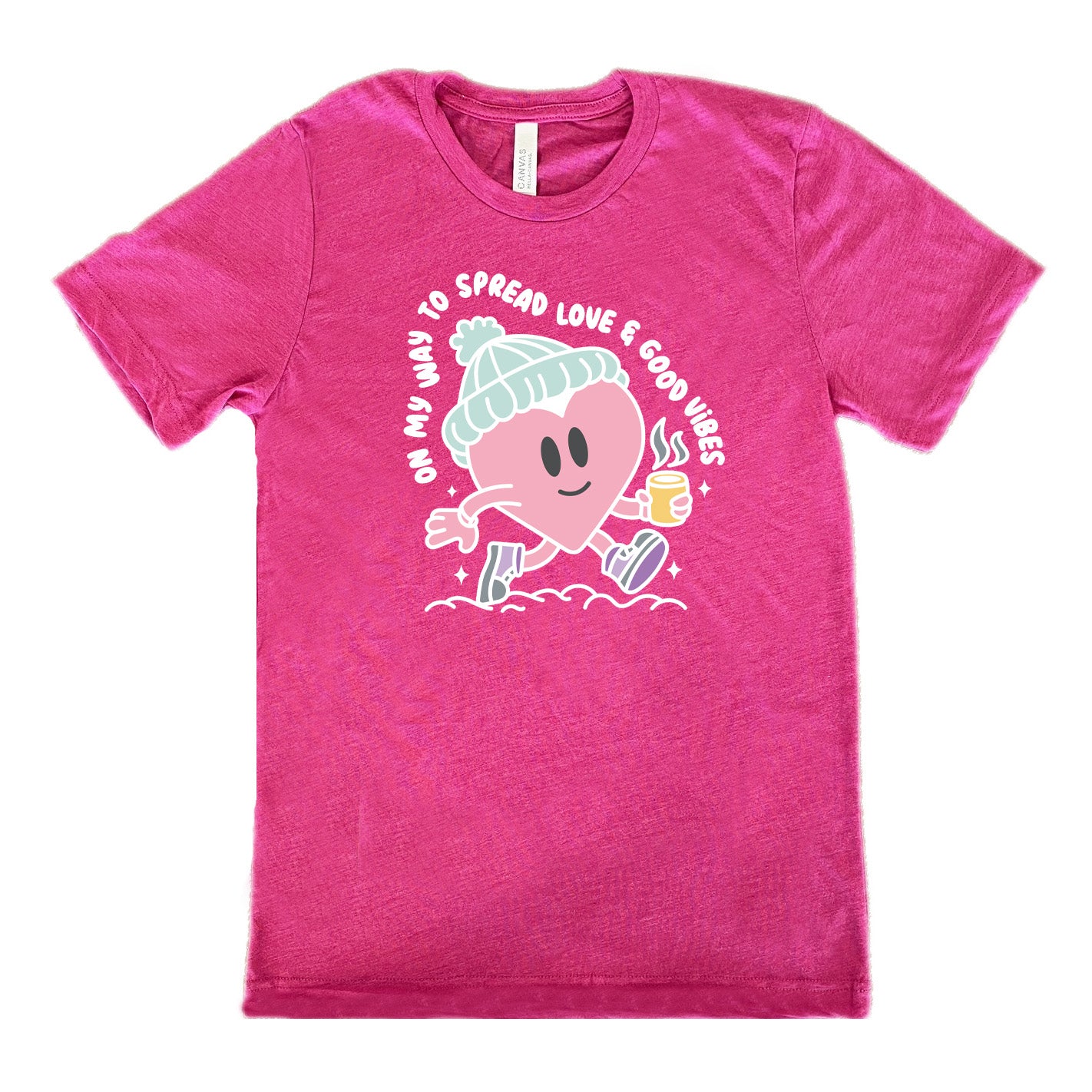 berry unisex tee with the words "on my way to spread love & good vibes" on it, with graphics of a cheerful, cartoony heart strolling along with a mug of a hot drink steaming in its hand, a hat on its head, and shoes on