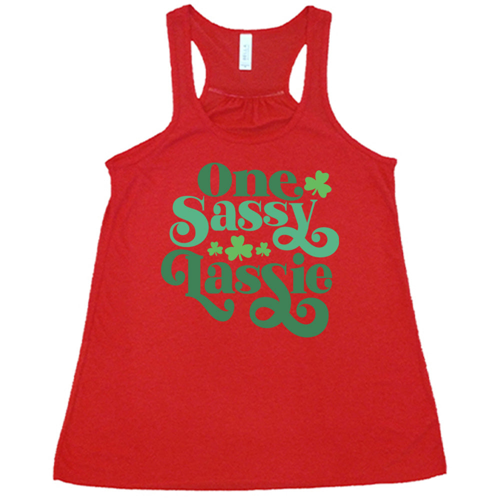 red flowy tank with the words "one sassy lassie" on it, with a few shamrock graphics