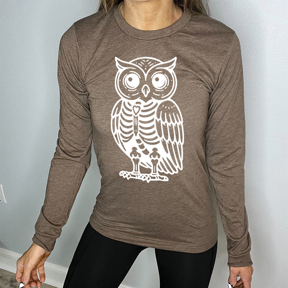 heather brown long sleeve tee with the large graphic of an owl with part of its body in skeletal form, with a little heart in the middle of its ribcage