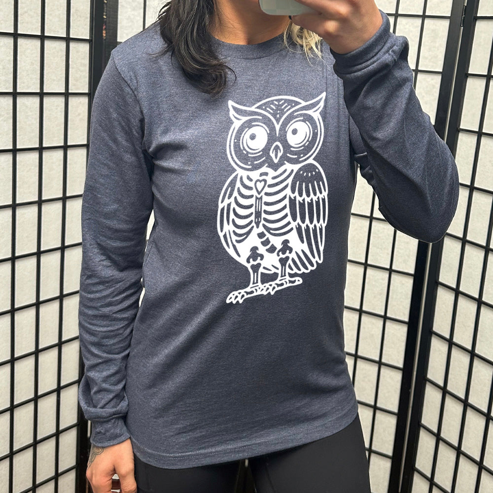 heather navy long sleeve tee with the large graphic of an owl with part of its body in skeletal form, with a little heart in the middle of its ribcage