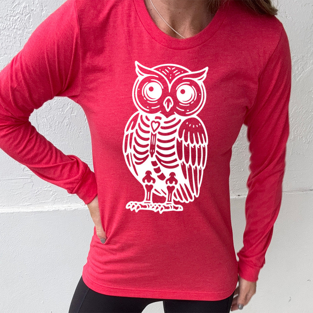 heather red long sleeve tee with the large graphic of an owl with part of its body in skeletal form, with a little heart in the middle of its ribcage