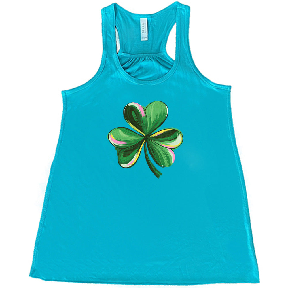 teal shirt with a painted shamrock graphic on it