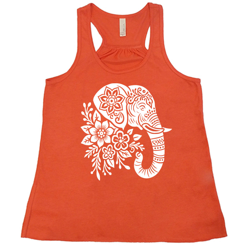 coral racerback tank with the large graphic of the profile of an elephant's head, with flowers for a torso, and patterns lining its truck and flowers patterned into its ear and forehead