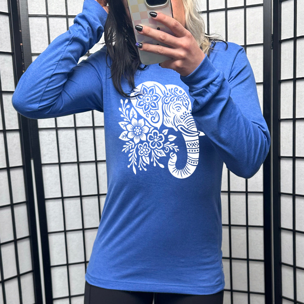 heather true royal long sleeve tee with the large graphic of the profile of an elephant's head, with flowers for a torso, and patterns lining its truck and flowers patterned into its ear and forehead
