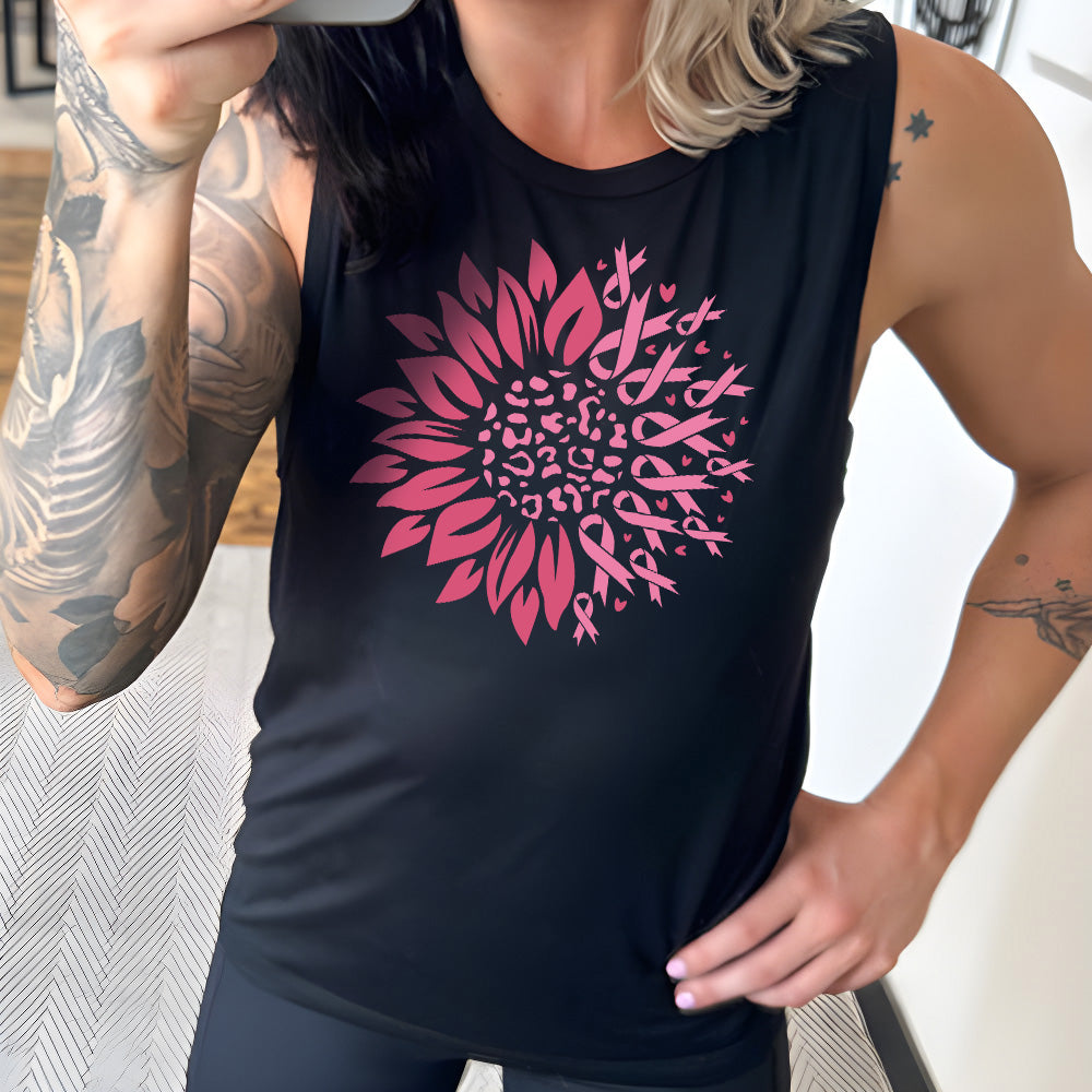Person wearing a black sleeveless shirt with a pink floral design featuring breast cancer awareness ribbons
