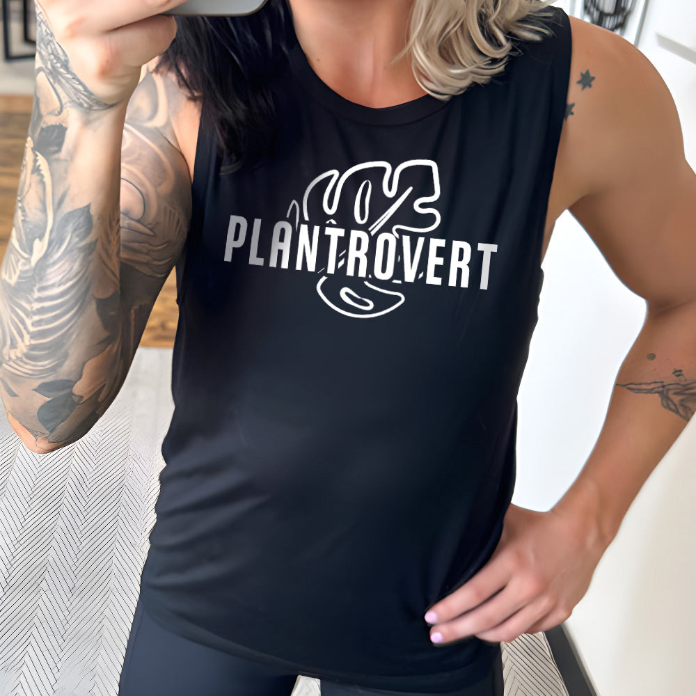 Model wearing black colored muscle tank with a leaf graphic on it that says "Plantrovert"