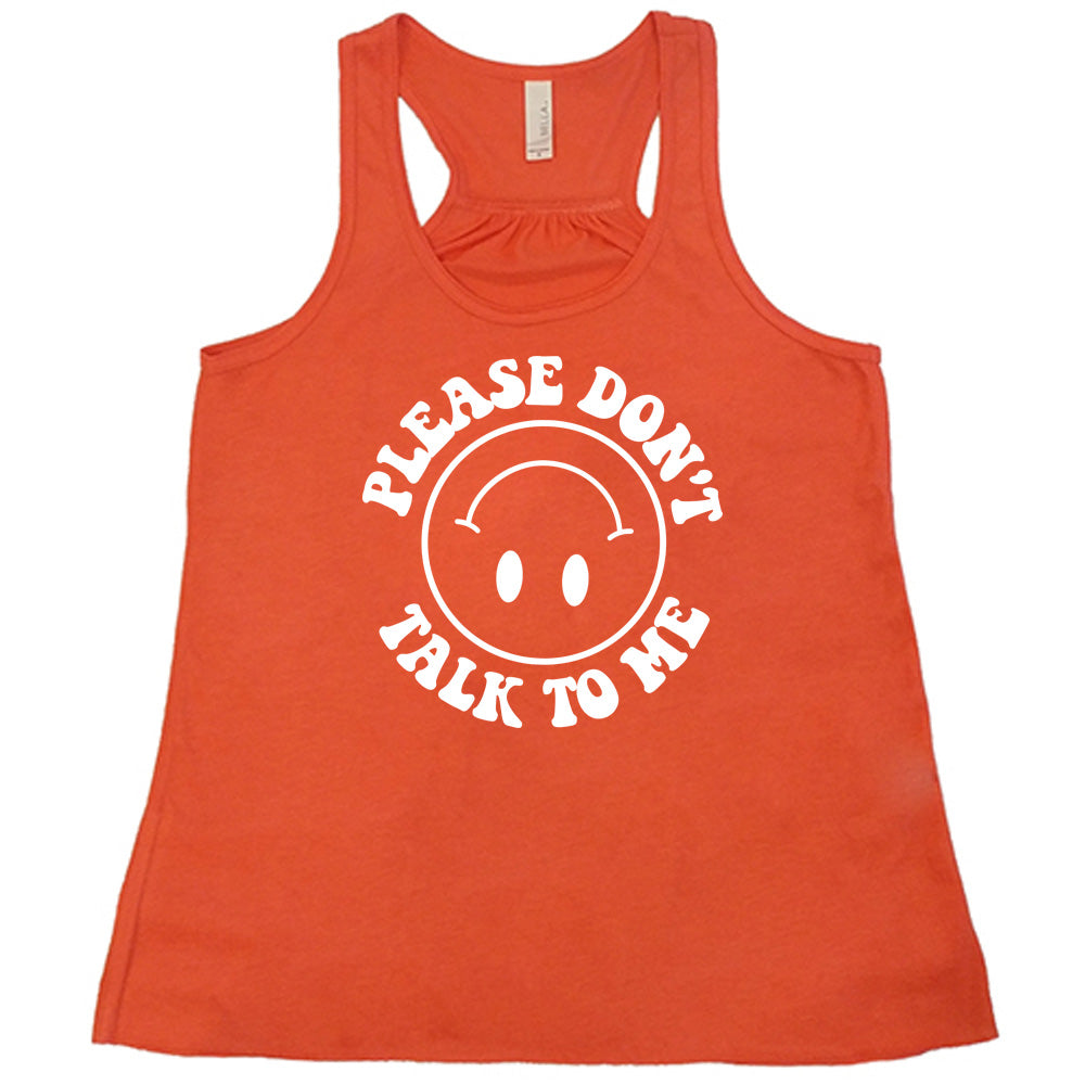 coral flowy tank with the words "please don't talk to me" creating mirrored arcs around the outlined circle graphic of an upside-down happy face
