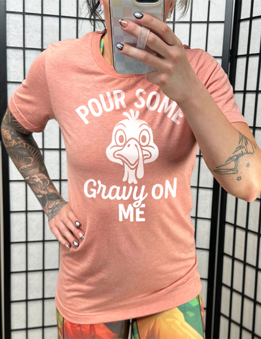 sunset unisex tee with the words "pour some gravy on me" on it, with "gravy" in cursive", and the words "pour some" slightly arching over the graphic of a turkey's head, eyes wide