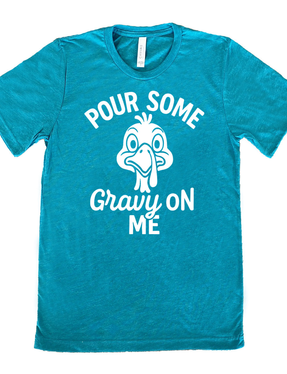 teal unisex tee with the words "pour some gravy on me" on it, with "gravy" in cursive", and the words "pour some" slightly arching over the graphic of a turkey's head, eyes wide
