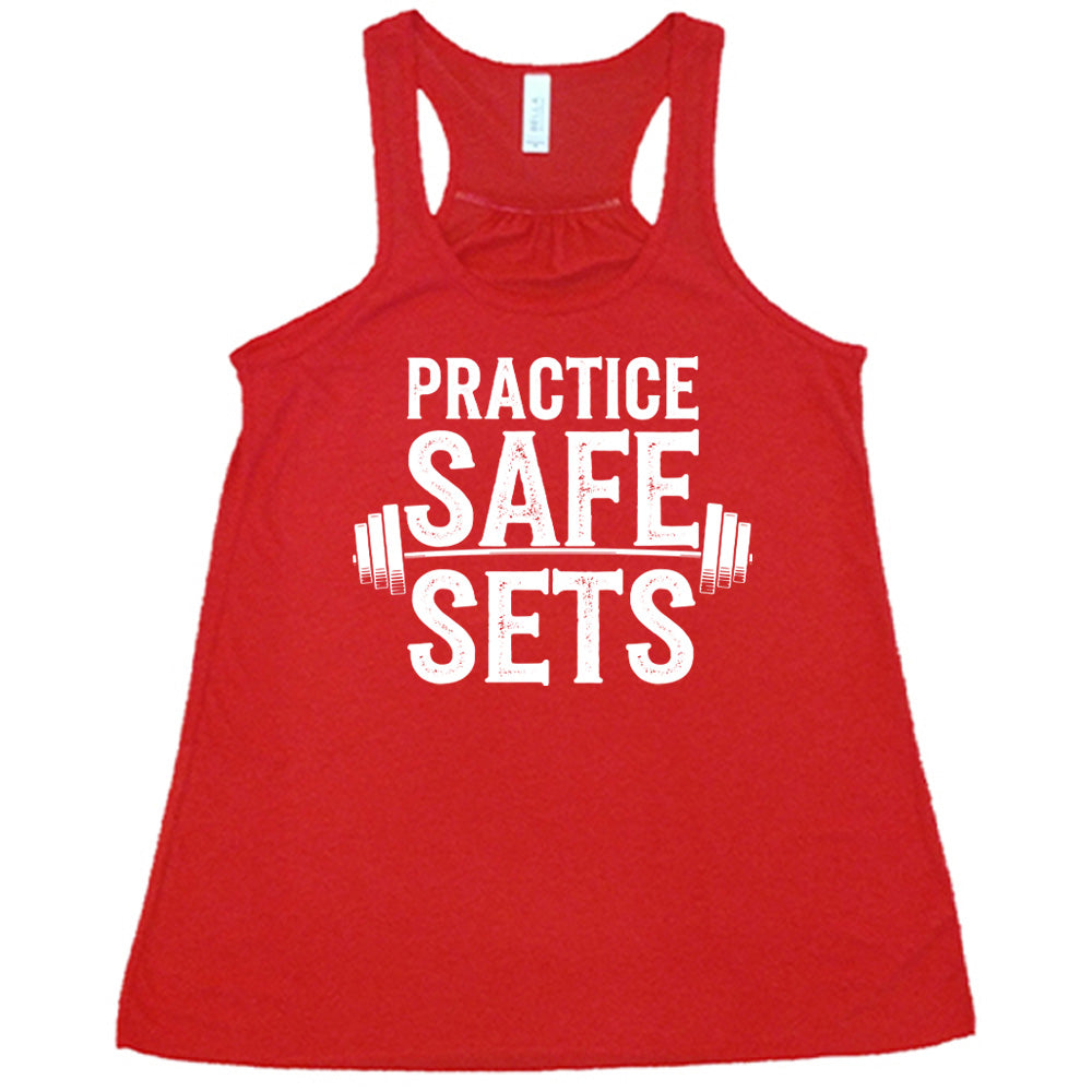red flowy tanks with the words "practice safe sets" on it, with the image of a barbell