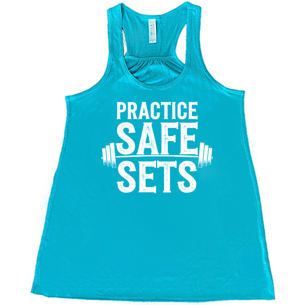 teal flowy tanks with the words "practice safe sets" on it, with the image of a barbell