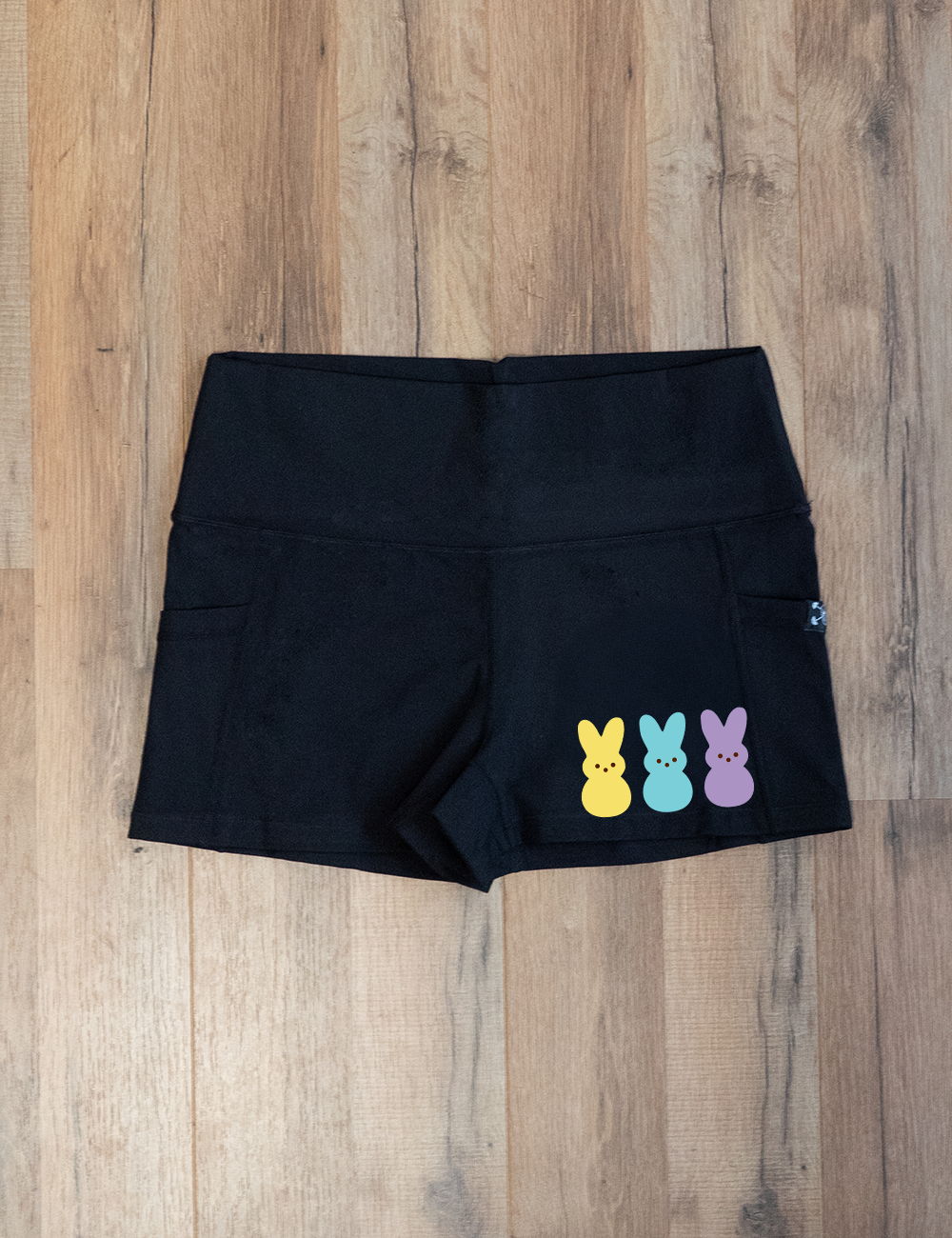 black 2.5" shorts with a yellow, blue, and purple colored peeps on the right side