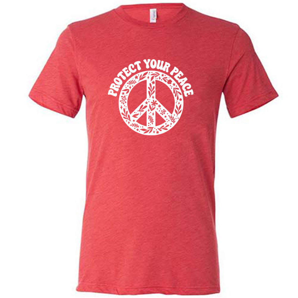 red shirt with the text "protect your peace" and a peace sign graphic on it