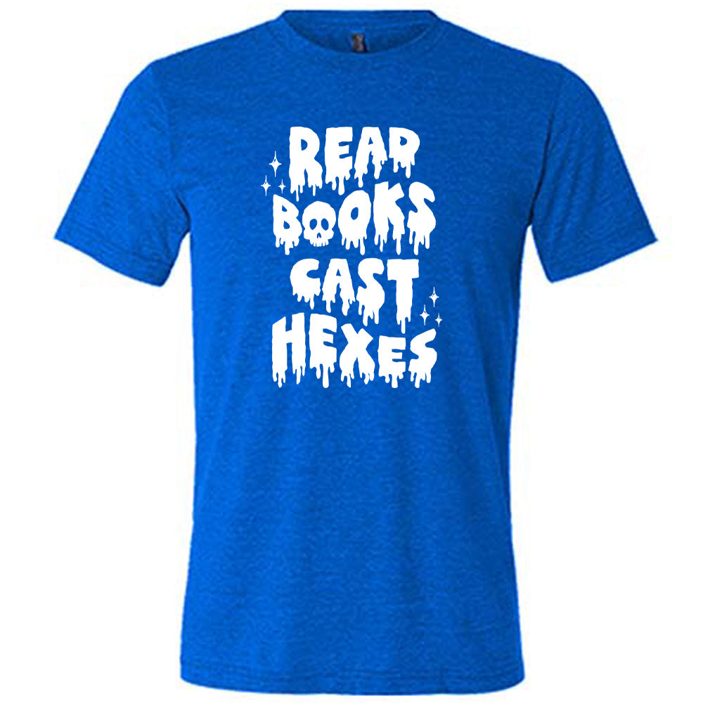 blue shirt with the text "Read Books Cast Hexes" on it