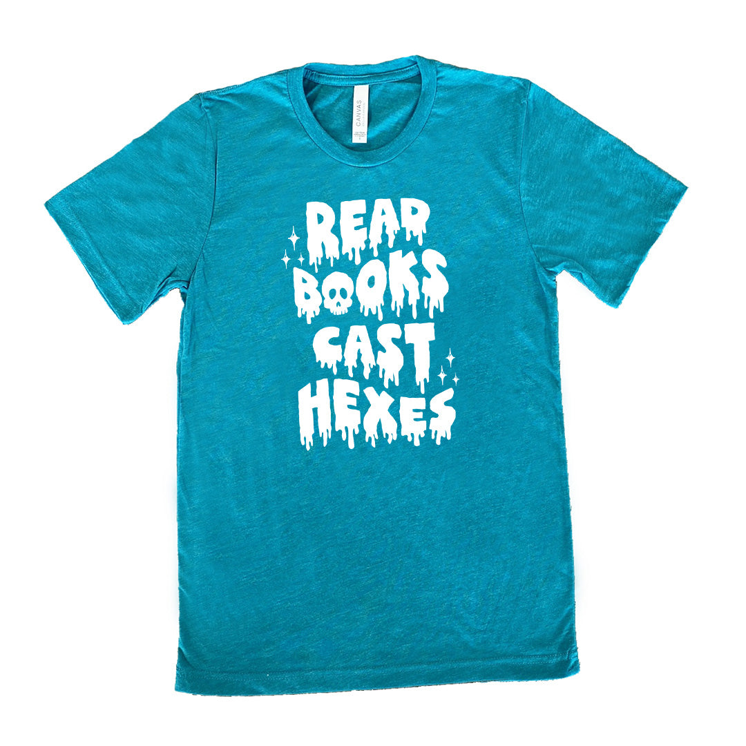 teal shirt with the text "Read Books Cast Hexes" on it