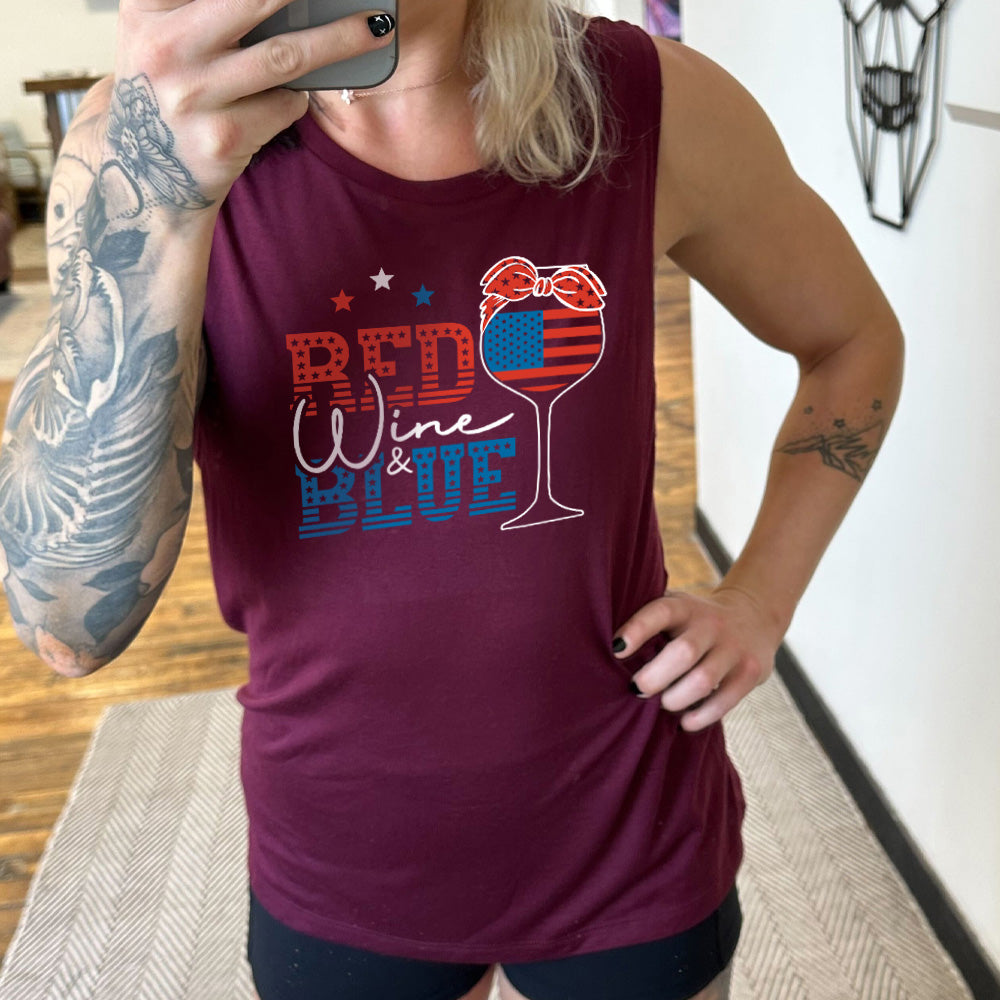 Model wearing maroon colored muscle tank with an American flag wine glass graphic on it that says "Red Wine & Blue"