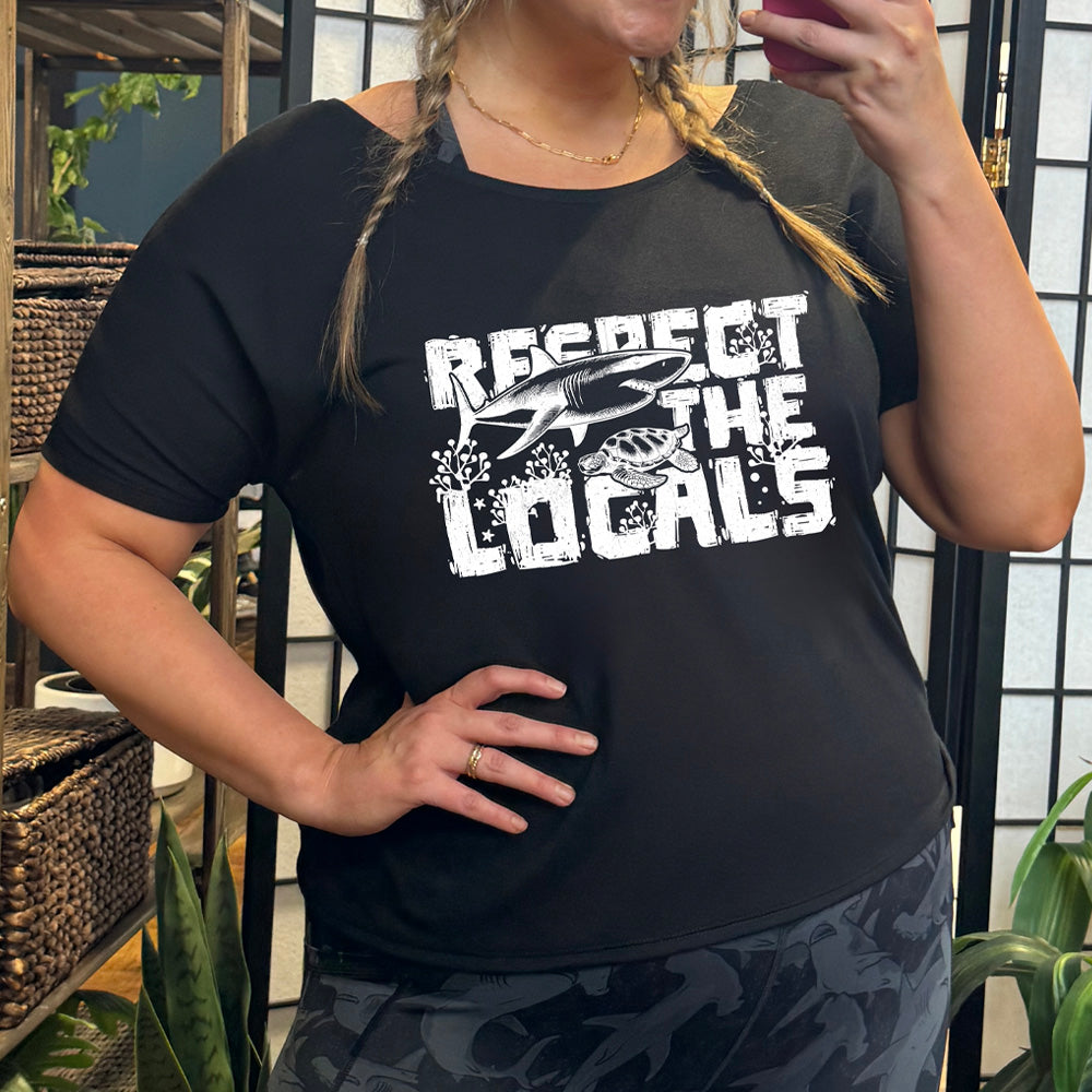 Black colored shirt with a shark and turtle graphic on it that says "Respect The Locals" 