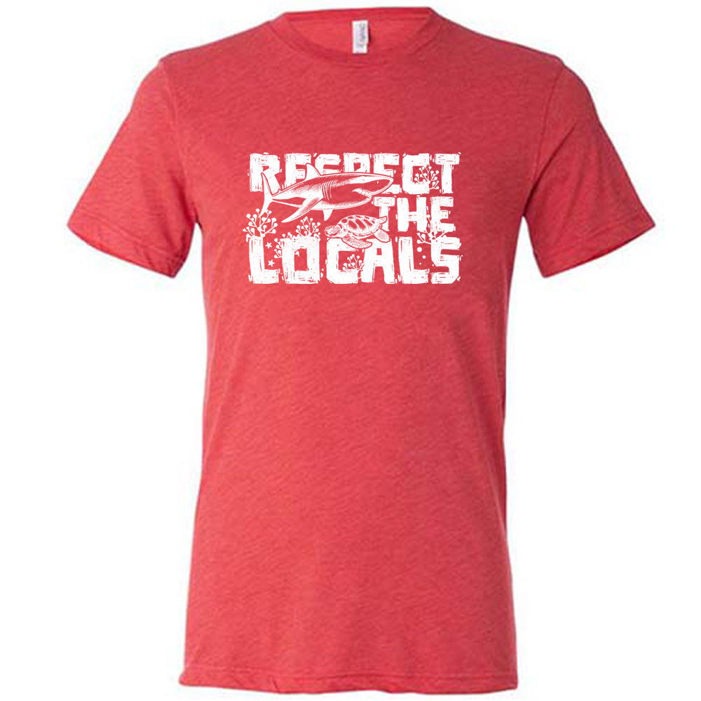 Red colored shirt with a shark and turtle graphic on it that says "Respect The Locals" 