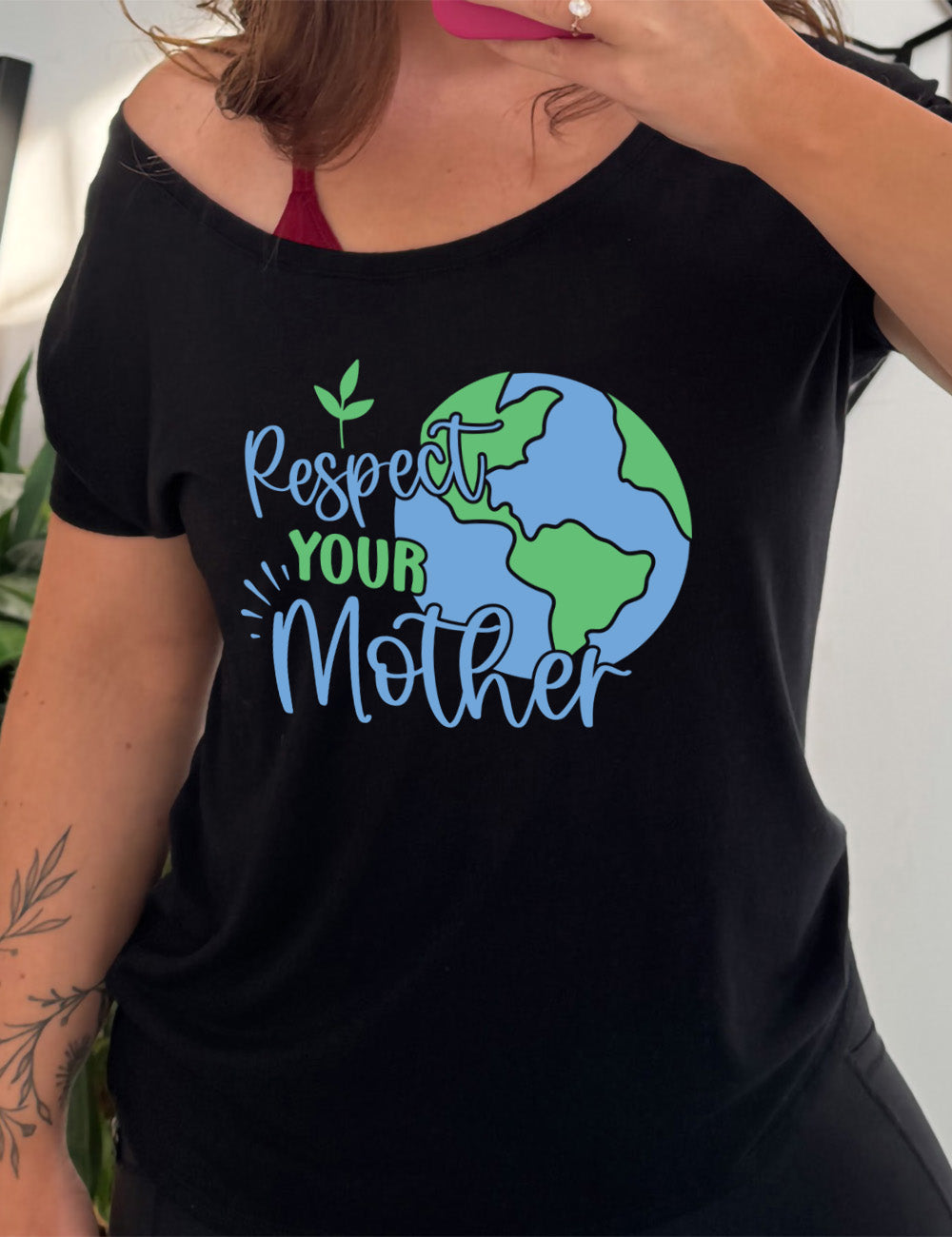 black slouchy tee with the graphic of the earth, and the words overlapping it saying "Respect Your Mother"