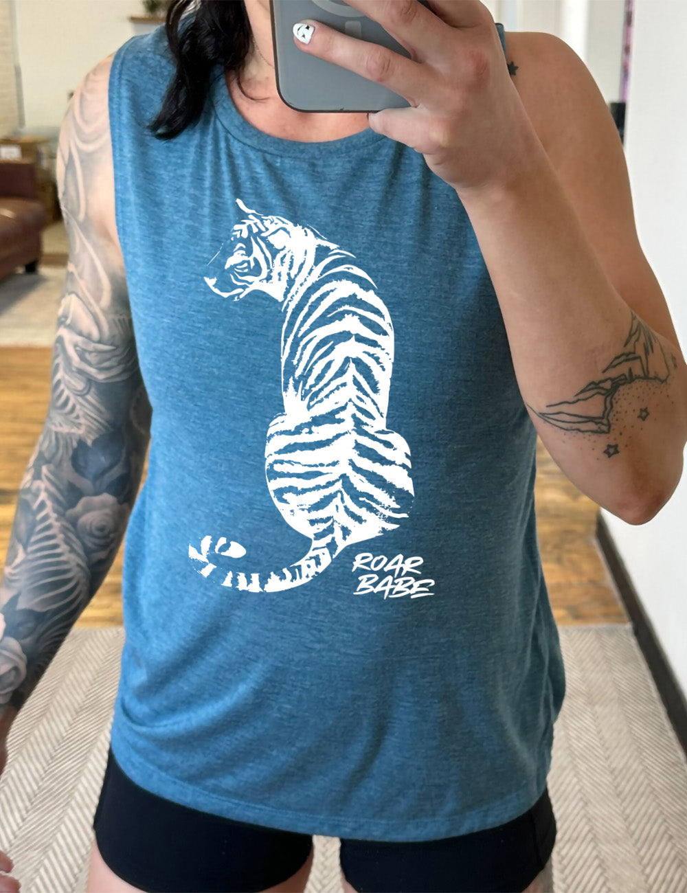 deep teal muscle tank with the graphic of a tiger, from the back, sitting, looking to one side, with the words "roar babe" in small font underneath